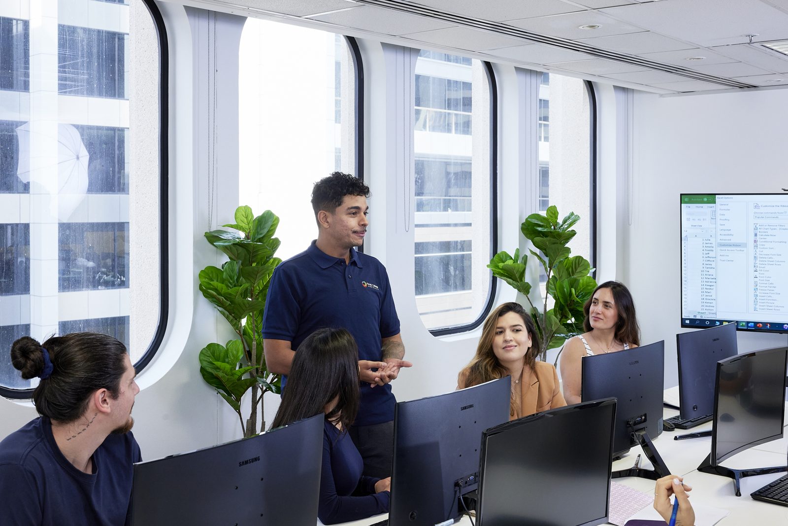 Students in discussion with their trainer during a classroom training session